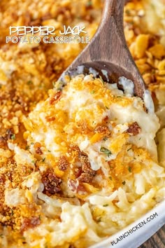 a casserole dish with cheese and other toppings in a white bowl on a wooden spoon