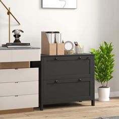 a black and white dresser with two drawers in front of a painting on the wall