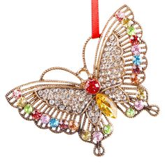 an ornament shaped like a butterfly with multicolored stones on it's wings