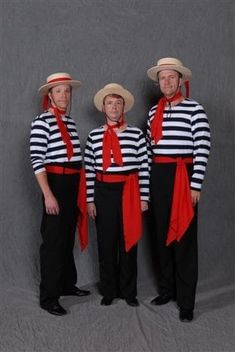 three men in striped shirts and hats posing for a photo