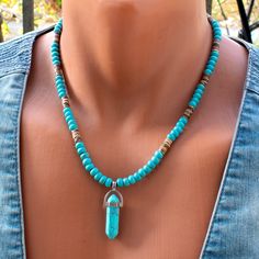 Elevate your style with this Turquoise Point Pendant Beaded Necklace, a unique fusion of turquoise and brown wood coconut beads designed for both men and women. The striking turquoise point pendant, centered amidst 6mm turquoise and brown wood beads, creates a harmonious balance of color and texture. Crafted with durable steel wire and a secure clasp, this necklace is a versatile accessory that seamlessly blends natural elegance with a touch of boho charm. Necklace length - 19 inches + 2 in chai Bead Necklace For Men, Men Boho, Turquoise Necklaces, Turquoise And Brown, Aventurine Necklace, Turquoise Pendant Necklace, Necklace Stone, Wood Bead Necklace, Handmade Jewel