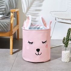 a pink bunny rabbit storage bin next to a cactus