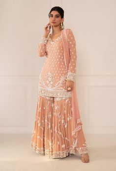 Editor's Note Featuring Peach Pink Embroidered Shirt & Gharara Set With Dupatta Fabric: Silk, Chiffon Color: Peach Pink  Embroidery Details: Zardozi Hand Embroidery Care: Dry Clean Only... Peach Indian Outfit, Sharara Suit Designs Latest, Pink Gharara, Traditional Dresses Indian, Peach Color Dress, Punjabi Suit Boutique, Sharara Designs, Pink Embroidery, Indian Dresses Traditional