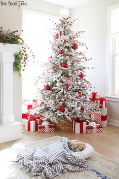 a white christmas tree with red and silver ornaments