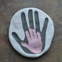 a hand painted on the side of a white and gray circle with pink writing that says brown is for 2012