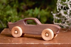 a wooden toy car sitting on top of a table