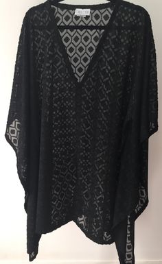 One-size Kaftan  Polyester Blend  Vibrant Diamond Texture  Knee-Length Designed and Manufactured in Canada Black Long Sleeve Beach Poncho, Black Long Sleeve Poncho For Beach, Black Poncho For Summer, Black V-neck Blouse For Beach, Black Stretch Beach Blouse, Stretch Black Beach Blouse, Beach Stretch Black Blouse, Black V-neck Beach Blouse, Black Poncho For Vacation