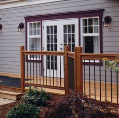 a house with a deck and stairs leading to the front door