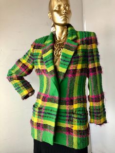 MARY ANN RESTIRO stunning  wool and mohair blazer tailored single breasted jacket for special occasions  semi-fitted green pink and yellow windowpane plaid blazer  all the plaids are skillfully matched low v front with one button closure exquisite wool and mohair fabric brilliant bold color and plaid combination strong shoulders with  shoulder pads notched lapels  set in long sleeves with tailored cuffs  one welt breast pocket and two hip front welt pockets set in long sleeves with tailored cuffs  below hip length jacket fully lined designer jacket good condition- the workmanship is splendid  1980s sustainable vintage  made in in the USA SZ 10  bust 36" waist 32" hips 38" jacket length 30" sleeve length 23" shoulder width16.5" Single Breasted Wool Blazer For Party, Party Wool Single Breasted Blazer, Wool Single Breasted Blazer For Party, Green Spring Tweed Jacket For Office, Green Tweed Jacket For Spring Office Wear, Tailored Green Tweed Jacket For Fall, Green Single Breasted Tweed Jacket For Formal Occasions, Fitted Green Tweed Jacket For Winter, Wool Blazer For Fall Party