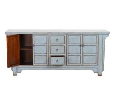 an old white cabinet with drawers and doors