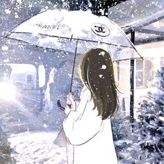 a woman holding an umbrella in the snow