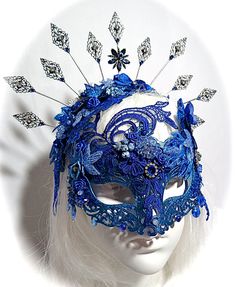 "This opulent masquerade mask is deep sapphire blue and ocean blue with lace overlays and beaded appliques that surround the crown and cheeks. The molded mask is painstakingly loaded with beads, gems, vintage trims and silver accents. Vintage flowers and ropes of beads are featured on each side. Rhinestones, lucite flowers and silver filigree metal work and drops add elegant touches. There are easily adjustable aluminum ear pieces to wear this mask without ties to mess up a hairdo and is fully f Maskerade Ball Mask, Moon Mask Masquerade, Blue Mask Masquerade Ball, Dark Blue Masquerade Mask, Blue Masquerade Dress, Elegant Masquerade Mask, Blue Masquerade Mask, Fantasy Crowns, Dream Thieves