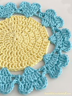 a crocheted doily with blue and yellow colors