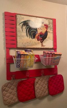 two baskets are hanging on the wall with red shutters and rooster artwork above them