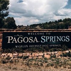 a welcome sign to pagosa springs in the desert