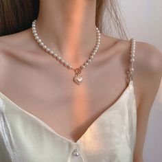 Toggle Clasp Heart Pendant Pearl Chain Choker Necklace This charming necklace features a delicate pearl chain with a lovely heart pendant and a convenient toggle clasp for easy wear. Enhance your look with a touch of romance and elegance. قلادات متدلية, Dainty Pearl Necklace, Diy Collier, Pearl Heart, Pearl Jewelry Necklace, Neck Jewellery, Pearl Choker Necklace, Valentines Necklace, Chain Choker Necklace