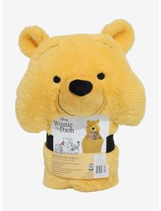 a yellow stuffed animal with a tag on it's chest and the words winnie the pooh