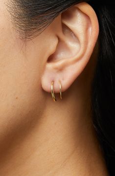 These hoops add the coolest detail to your look as they wrap around your ear, giving you the illusion of two piercings in one.How to wear: place thinner post through piercing. Turn earring approximately 2-3 times until both hoops are showing in the front to make a perfect double-pierced look. Avoid bending, style is delicate. Recycled Sterling Silver dipped in 14K Gold Delicate style, please handle with care Width: 5.5mm - 0.22" Depth: 13mm - 0.51" Weight: 0.60g Hoop Diameter: 13mm - 0.51” Post: Minimalist Gold Jewelry Earrings, Faux Double Hoop Earrings, Double Piercing Earrings, Two Piercings, Little Hoop Earrings, Double Earring, Gold Minimalist Jewelry, Double Earrings, Double Piercing