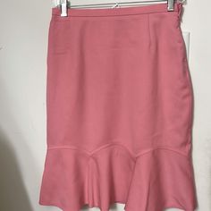 Salmon Pink Wool Skirt Side Zipper Fully Lined With Logo Fabric Above Knee Length New With Tags Feminine Fitted Midi Skirt, Elegant Knee-length Pink Bottoms, Elegant Pink Skirted Bottoms, Pink Flared Skirt Bottoms For Work, Elegant Pink Knee-length Bottoms, Pink Flared Skirt For Workwear, Fitted Ruffled Pencil Skirt For Summer, Elegant Ruffled Pencil Skirt For Spring, Ruffled Pencil Skirt For Workwear