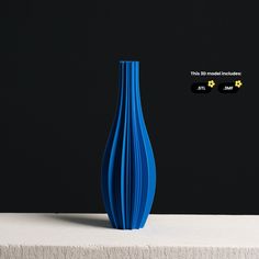 a blue vase sitting on top of a white table