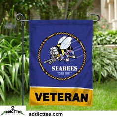 a blue and yellow garden flag with the words seabees care do it on it