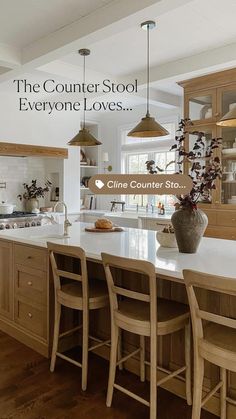 a large kitchen with an island in the middle and lots of stools around it