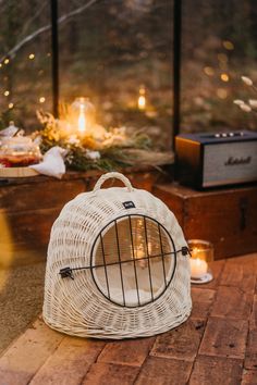 a white birdcage sitting on top of a wooden floor