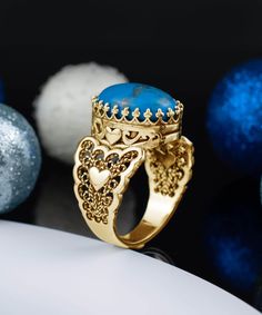 Add a pop of color to your jewelry collection with Filigranist's Gold Plated Sterling Silver Filigree Art Double Heart Detailed Turquoise Gemstone Women Statement Ring. Made from high-quality gold plated sterling silver, this ring features a stunning turquoise gemstone decoration that's sure to turn heads. The elegant filigree art design adds a touch of sophistication to any outfit, making it the perfect choice for any occasion. Express your unique sense of style and individuality with this eye- Heart-shaped Turquoise Blue Ring For Gift, Unique Turquoise Ring With Gemstone Accents, Unique Turquoise Ring With Gemstone Accents As Gift, Heart-shaped Blue Turquoise Ring For Gift, Heart-shaped Blue Turquoise Ring Gift, Unique Yellow Gold Turquoise Ring For Gift, Turquoise Ring With Gemstone Accents As Gift, Turquoise Rings With Gemstone Accents For Gift, Gold Turquoise Ring With Accent Stones For Gift