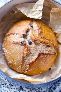 a loaf of bread sitting in a bowl on top of a table