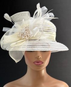 The hat featured here is an ivory and white lightweight linen and lace striped hat.  This is a one of a kind  hat  made by Letty. The hat is white with an ivory satin band. A crinoline design of white and ivory with several ivory feathers adorns the hat.  In the center of the crinoline design is a large cluster of off white pearls. Creating the look that suits you best can be achieved just by  turning the hat on your head creating a different look with each twist till you find the look you love.. This gorgeous  hat is a beautiful Church hat or a Kentucky Derby Hat.  Also perfect  for  an Easter Hat, Tea Party hat, Wedding Party Hat, Fancy Dress Hat, Retro Hat and other special occasions hat. Brim:   3" Rise:   3" Size:    22" White Vintage Fascinator For Royal Ascot, Vintage White Wedding Costume Hats And Headpieces, Vintage White Costume Hats And Headpieces For Wedding, Fitted Cream Costume Hats And Headpieces For Ceremony, White Vintage Wedding Costume Hats And Headpieces, Vintage White Costume Hats For Wedding, White Vintage Fascinator Hat, White Curved Brim Fascinator For Vintage Events, Vintage White Fascinator Hat