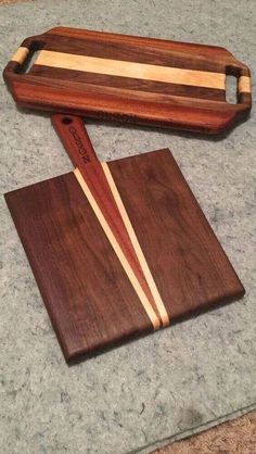 two wooden cutting boards sitting on top of a counter