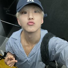 a person with a baseball cap on taking a selfie