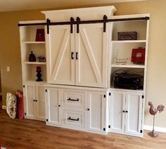 the entertainment center is built into the wall with sliding doors and drawers on each side