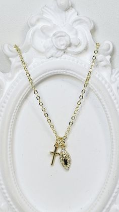 Gold Plated Brass Dainty 1mm Cable Chain is 16" with a 2" extender chain and lobster clasp. Necklace can be made shorter for children, by request in note section on order.  Gold Filled Brass Cross is 12x6mm Gold Filled Brass and Cubic Zirconia Mary Charm is 14.5x5.5mm Minimalist Gold Crucifix Charm Necklace, Dainty Charm Necklace With Cross Pendant, Tarnish Resistant, Dainty Yellow Gold Crucifix Necklace, Spiritual 14k Gold-filled Charm Necklace, 14k Gold-filled Spiritual Charm Necklace With Adjustable Chain, Catholic Jewelry, Gold Cross Necklace, Blessed Mother Mary, How To Make Shorts