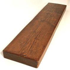 a close up of a wooden plank on a white surface