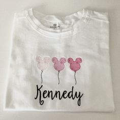 This short sleeve white tee is made of 100% organic cotton (I use Honest baby clothing brand) and is embroidered with your little one's name. Machine wash and dry on low. If you are wanting a different design, more wording, or a different clothing style, please send me a message so we can discuss the details. If you need this order rushed, please add these to your cart: https://www.etsy.com/listing/1043569716/rush-my-order-for-t-shirts?ref=shop_home_active_19&frs=1 Rush my order + Priority shipp Balloon Sketch, Mickey Mouse Balloon, Disneyland Sweatshirt, Disney Applique, Mickey Mouse Balloons, Honest Baby Products, Disney With A Toddler, Family Disney Trip, Disney Trip Shirts