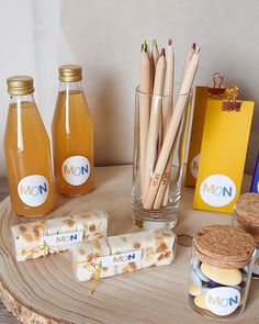 there are many different types of drinks on this wooden table, including lemonade and honey