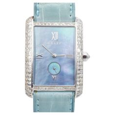 Graff Mother of Pearl and diamond wristwatch. The watch features rectangular Mother of pearl dial, case accented with round and square shaped diamonds, equipped with blue leather strap. Automatic movement. Crafted in platinum and 18k white gold. There is 120 of square cut diamonds and one round brilliant cut diamond, with total carat weight of approximately 4.00ct, color G-H, clarity VS. Signed: Graff London. Numbered: 0043. Marked: PT950, Platinum, G XXXII (case), 750 (clasp) and Swiss Marks. C Timeless Blue Rectangular Watch, Blue Rectangular Timeless Watch, Luxury Rectangular Diamond Watch For Evening, Rectangular Diamond Watch With Diamond Hour Markers For Evening, Luxury Blue Watches For Evening, Elegant Blue Rectangular Watch, Luxury Blue Evening Watch, Blue Diamond Watches For Formal Occasions, Formal Blue Diamond Watches