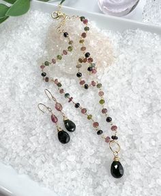 Beautiful necklace & earring set with faceted Watermelon Tourmaline gemstones. All gold filled components. The necklace consists of faceted Watermelon Tourmaline that is hand wrapped into a rosary style chain and includes the Green Tourmaline removable pendant. It is finished off with a lobster clasp & dangle of gold filled beads. Necklace measures 16-18" and can be adjusted anywhere in between. Pendant measures 7/8" long X 3/8" wide. The earrings have smooth Watermelon Tourmaline stones accente Tourmaline Briolette Jewelry With Natural Stones, Briolette Tourmaline Jewelry With Natural Stones, Tourmaline Jewelry With Natural Stones For Jewelry Making, Tourmaline Jewelry With Round Beads As Gift, Dainty Tourmaline Gemstone Beads Jewelry, Faceted Beads Dangle Jewelry Gift, Handmade Tourmaline Dangle Jewelry, Tourmaline Jewelry With Natural Stones For Gifts, Faceted Beads Lariat Jewelry For Gift