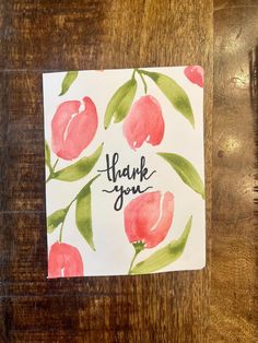 a thank card with watercolor flowers on it