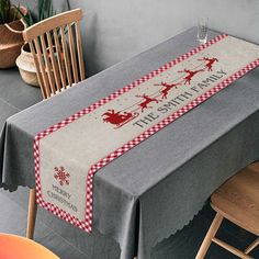 the table is covered with a red and white checkerboard christmas runner that says, this smithy merry christmas