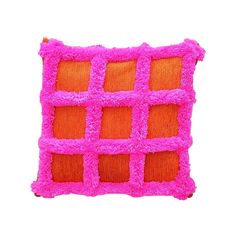 an orange and pink pillow with squares on it's sides, against a white background