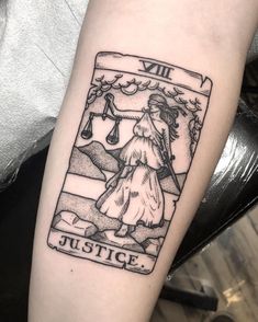 a lady justice tattoo on the arm