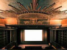 an empty auditorium with rows of seats in it