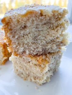 two pieces of white cake sitting on top of a white plate next to each other