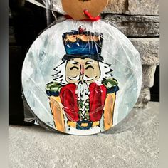 a glass plate with an image of a nutcracker on it, sitting next to a brick wall