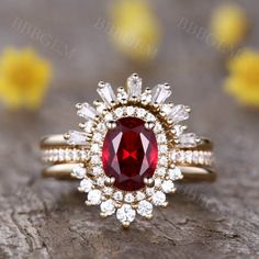 a close up view of a ring with a red stone and white stones on it