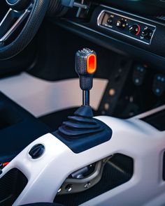 the interior of a car with a steering wheel and gauges on it's center console