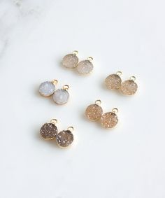 "Our NEW Rey Druzy Circle Drop Earrings are a perfect go to option for your work day to your date night. This lightweight, classic design features natural druzy drops in neutral hues and 14k gold filled circles that are lightly hammered for added texture and shimmer. Ordering 4 or more for Bridesmaids or a special occasion? Please contact us for special pricing and stock availability. *CUSTOMIZE by selecting the color Druzy drops you love. See photos for options. MATERIALS: Natural Druzy | 14k G How To Make Druzy Earrings, Handmade 14k Gold-filled Teardrop Earrings, Nickel-free Round Crystal Earrings For Everyday, 14k Gold-filled Teardrop Natural Stone Earrings, Raw Stone Earring, Boho Hoop Earrings, Silver Chain Earrings, Crystal Chandelier Earrings, Book Earrings