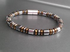 Elegant mens (or unisex) magnetic bracelet... This bracelet features metallic finish magnetic beads… silver finish magnetic beads with copper finish accents, and an extra strength 7mm silver magnetic clasp. All of our Magnetic Jewelry features High Quality AAA Grade Magnetic Beads, Silver Magnetic Beaded Bracelets With Round Beads, Silver Beaded Bracelets With Magnetic Round Beads, Mens Bracelet Diy, Bracelets Outfit, Mens Bracelet Designs, Male Jewelry, Magnetic Beads, Men's Necklaces, Men Bracelets